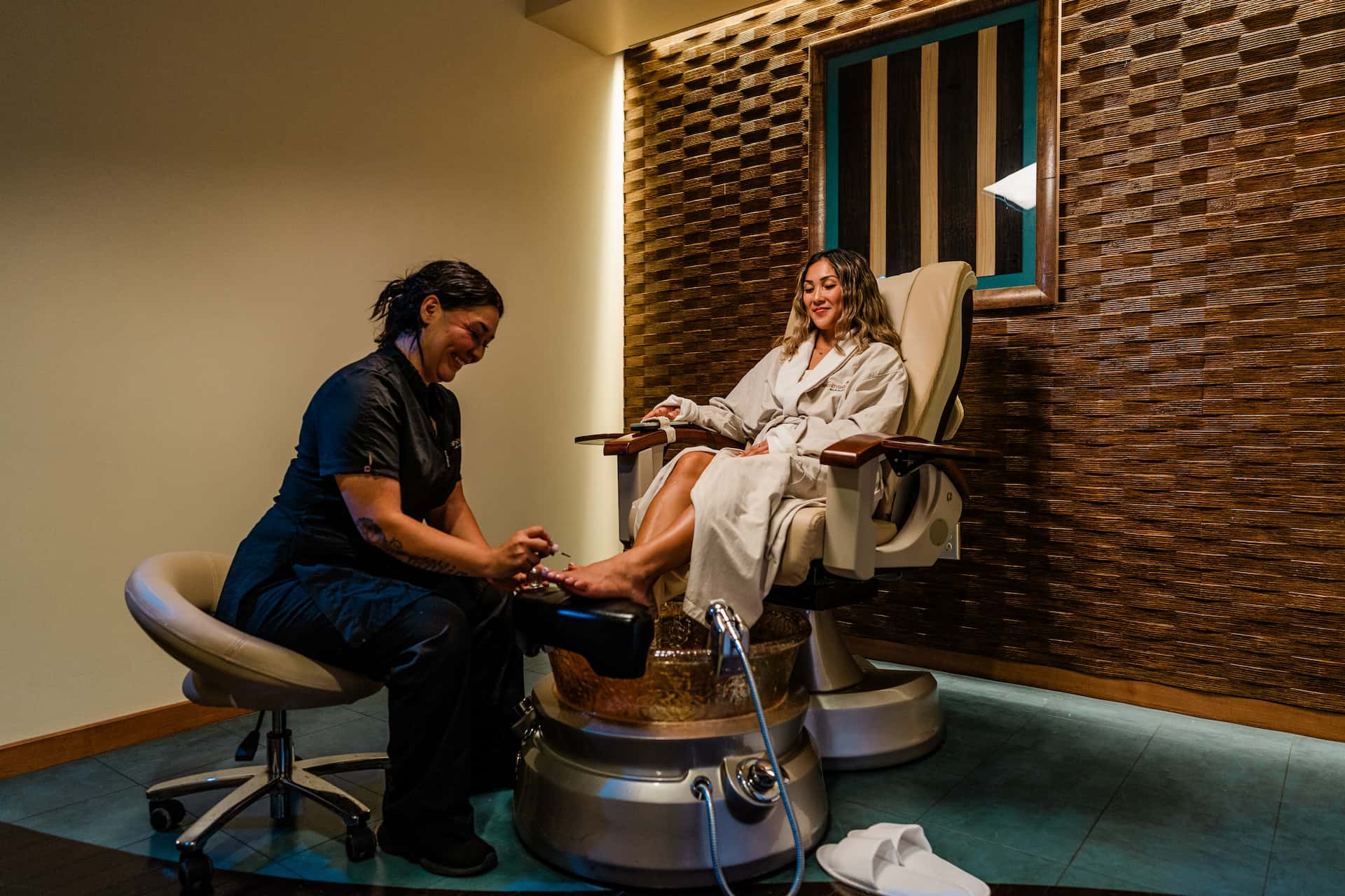 woman giving pedicure to client